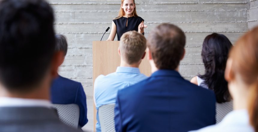 Businesswoman,Addressing,Delegates,At,Conference