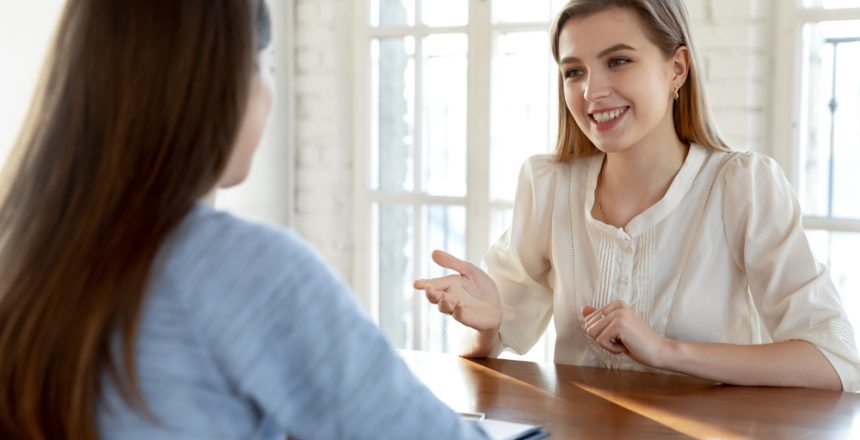 Smiling,Confident,Beautiful,Young,Woman,Involved,In,Conversation,With,Hr