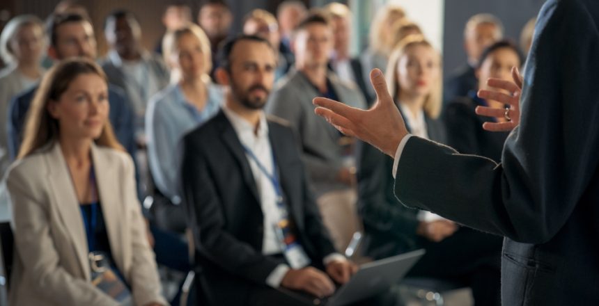 Back,View,Of,Environment,Specialist,Gesturing,And,Presenting,To,Audience